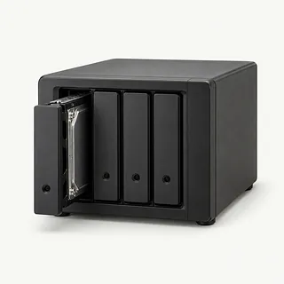 Four-bay network storage box in matte black, front angled view with one drive tray pulled halfway out