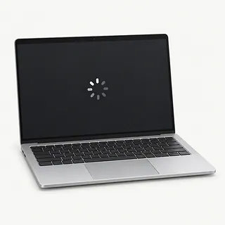 Laptop in silver, open front view with a black keyboard and a white loading spinner on a dark screen