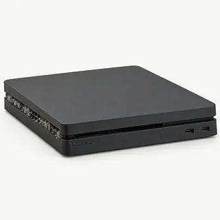 Black PS4 viewed from the front and side with side vents clogged with gray dust and lint