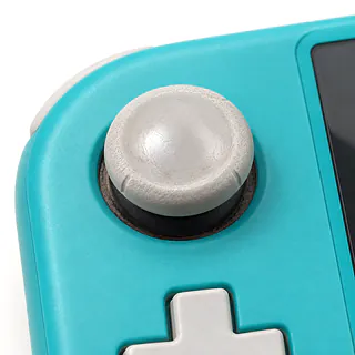 Nintendo Switch Lite in turquoise, left analog stick close-up with a worn white rubber cap and grime around the base