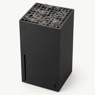 Xbox Series X in black, front and top view with vents clogged by thick gray dust and lint